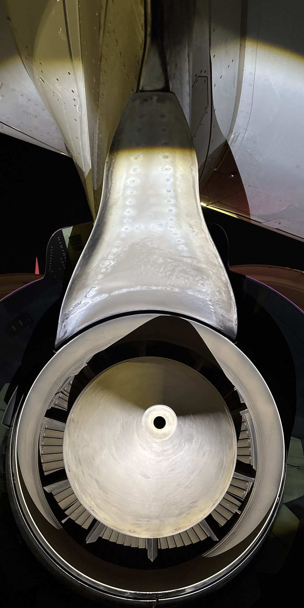 Engine exhaust and pylon photographed during a night-time aircraft inspection